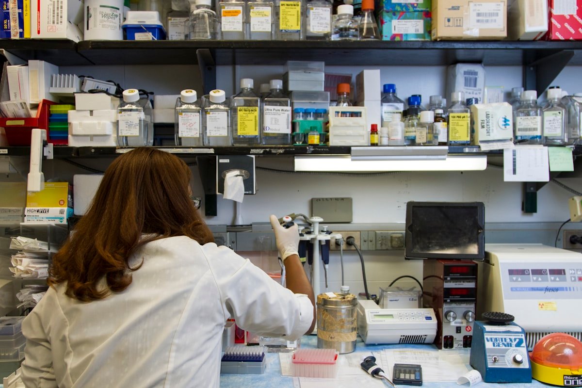 Laboratory professional retrieving supplies from stocked shelves